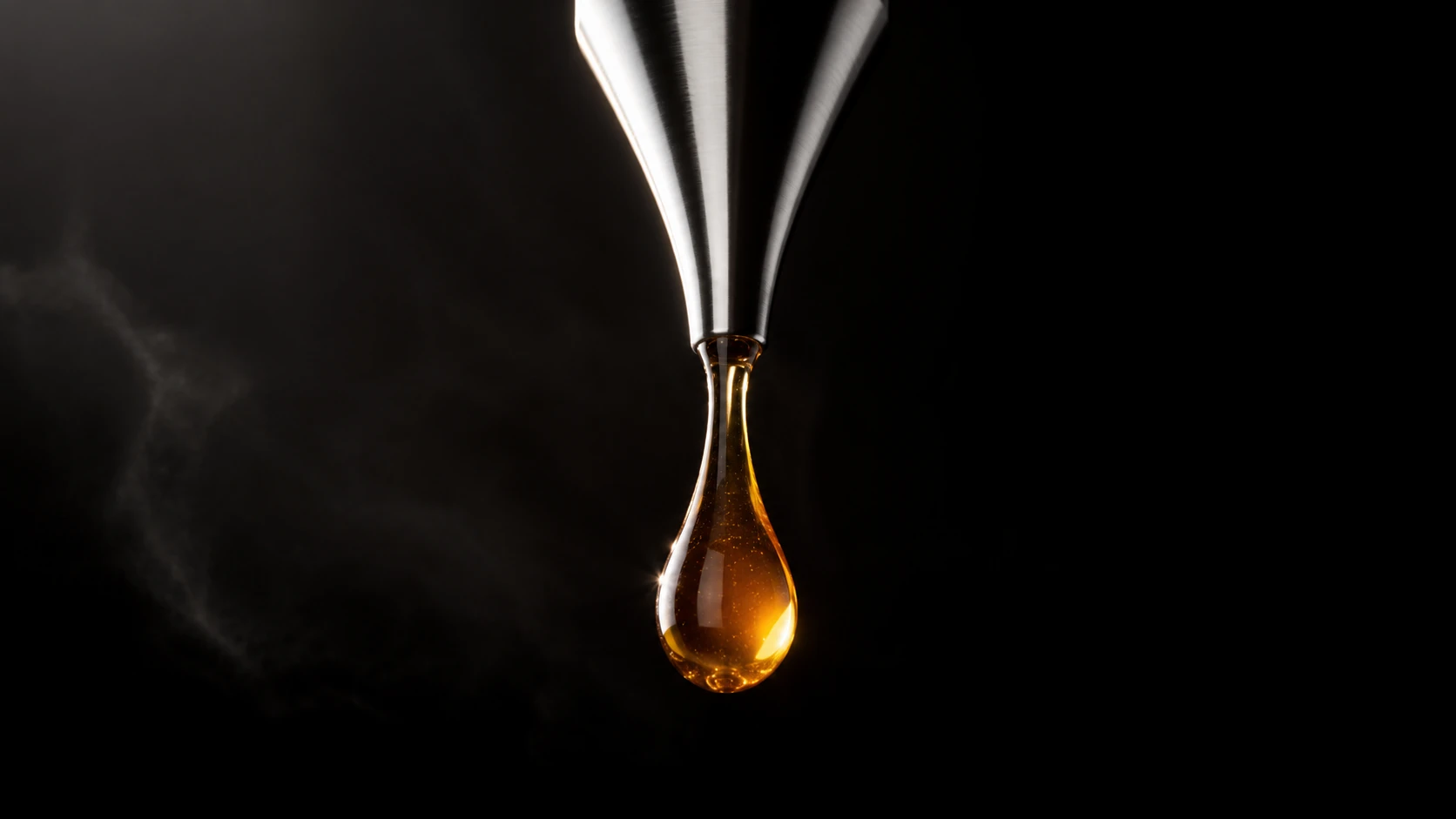 Close view of an amber droplet against a dark background