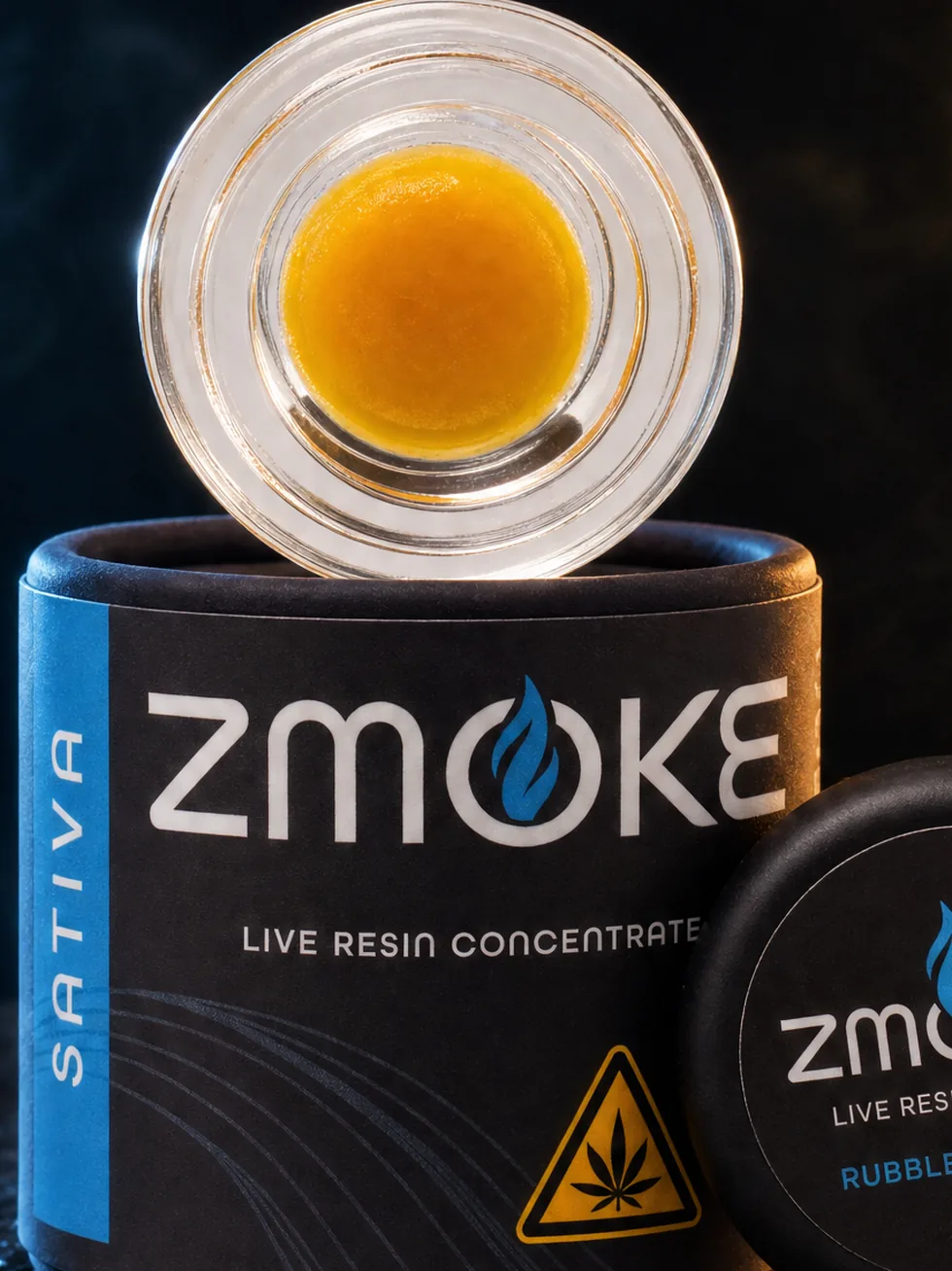 Blue Sativa ZMOKE live resin concentrate packaging staged on dark slate